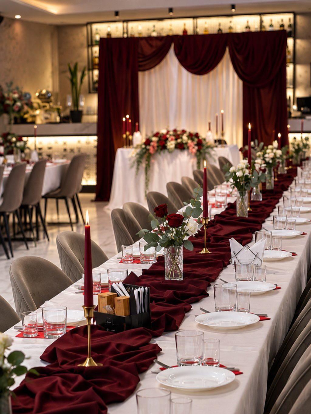 Dark Red Wedding Colors: 20 Ideas for Mood and Palette 17 A long wedding banquet table featuring dark red runners, gold candle holders, and red roses.