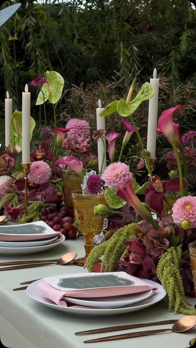 Dusty rose flowers and green anthuriums arranged in a lush centerpiece on a wedding table.