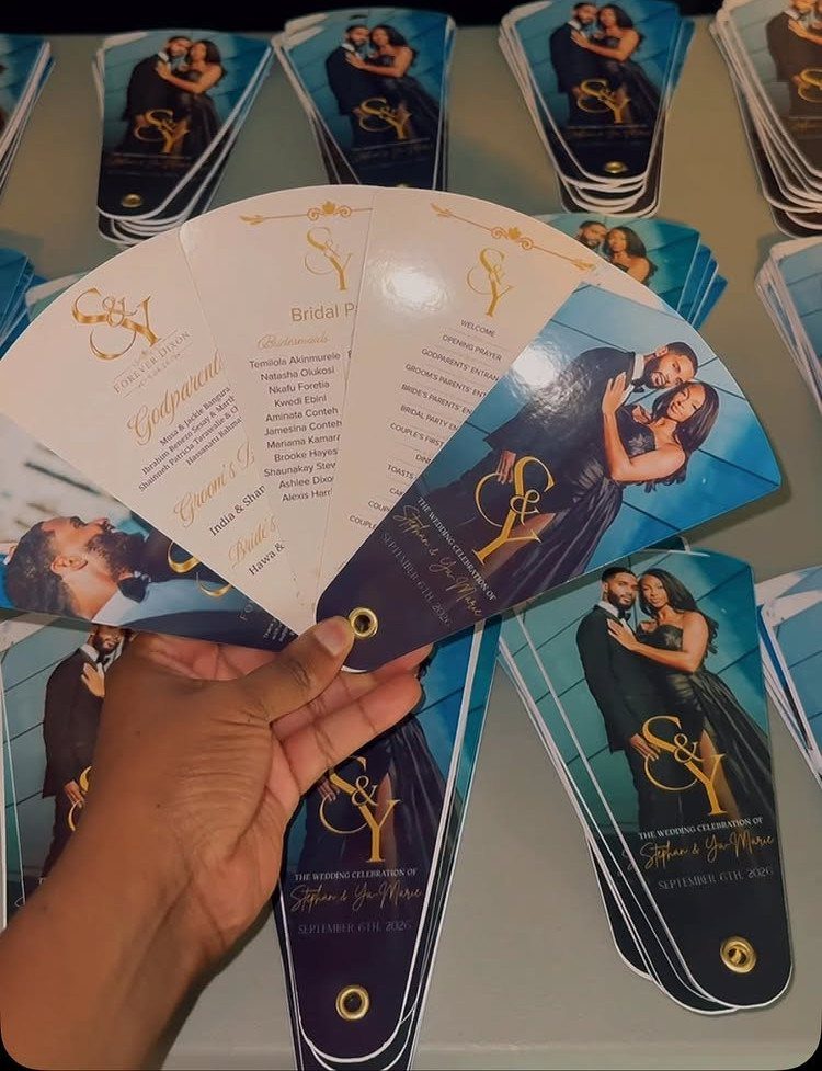 Green Gold White Wedding: 8 Ideas for Decor and Details 3 A hand holding several fan-shaped wedding ceremony programs featuring a couple's photo and gold text.