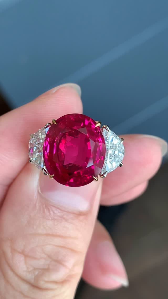 Precious Stones Jewelry: 11 Ideas From Emerald to Gold Bangles 6 A large oval ruby ring with side diamonds held between a person's fingers.