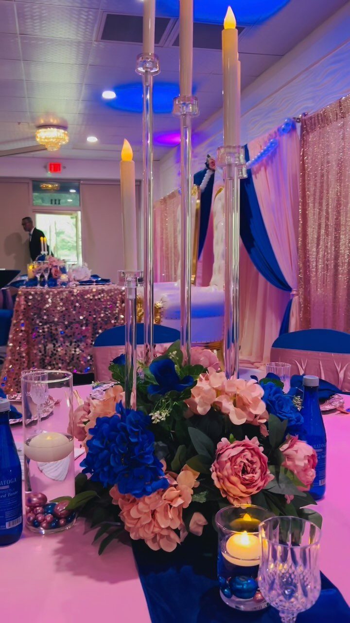 Wedding Colors Royal Blue: 9 Ideas for Your Reception 8 Royal blue and pink floral centerpiece with tall candles on a shimmering rose gold sequined tablecloth.