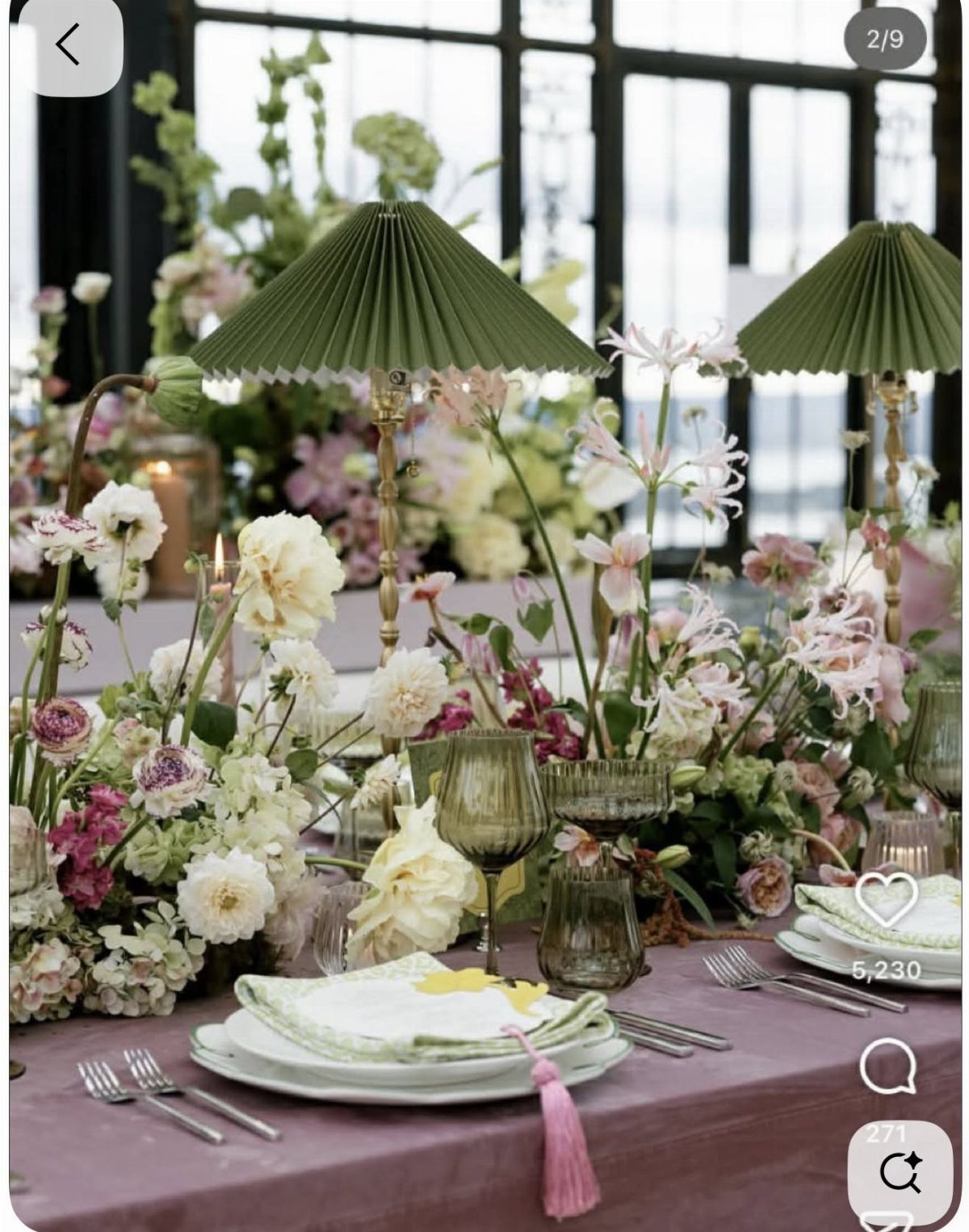 Floral wedding tablescape with pleated green umbrellas, textured glassware, and lush pink and white flowers.